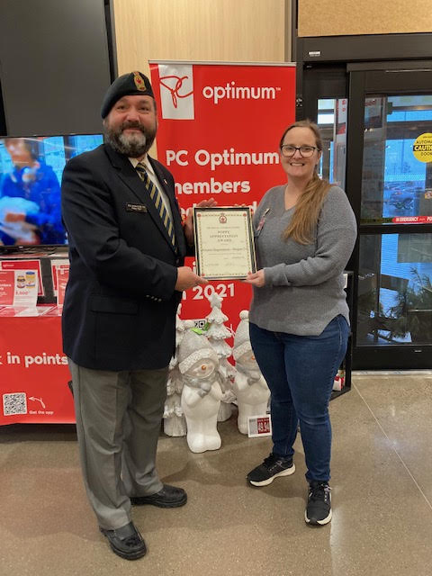 Comrade Rob Pitcher presents Lisa Cox from the Atlantic Superstore Hogan Court with a Certificate of Appreciation for their assistance during the 2022 Poppy Campaign