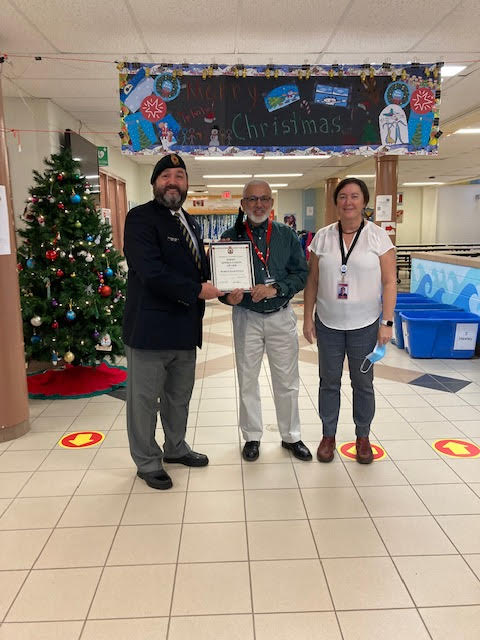 Comrade Rob Pitcher presents Tilik Aurora and Helen Healy from Bedford South Elementary School with a Certificate of Appreciation for their assistance during the 2022 Poppy Campaign