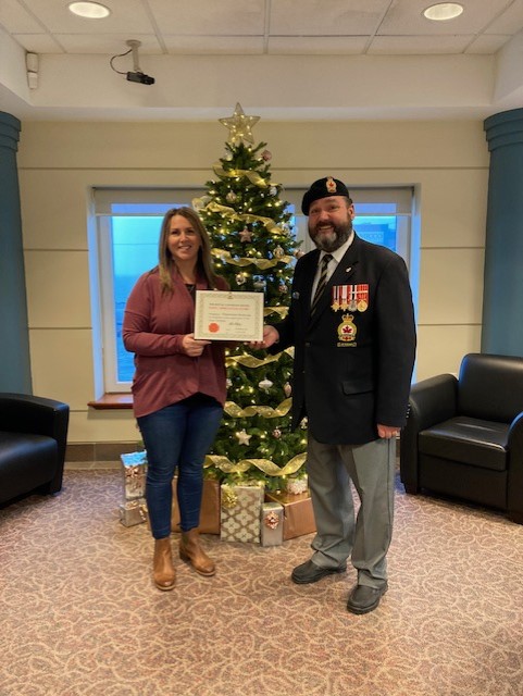 Catherine Warnika from Clearwater seafoods is presented a Certificate of Appreciation from Comrade Rob Pitcher for their assistance during the 2022 Poppy Campaign