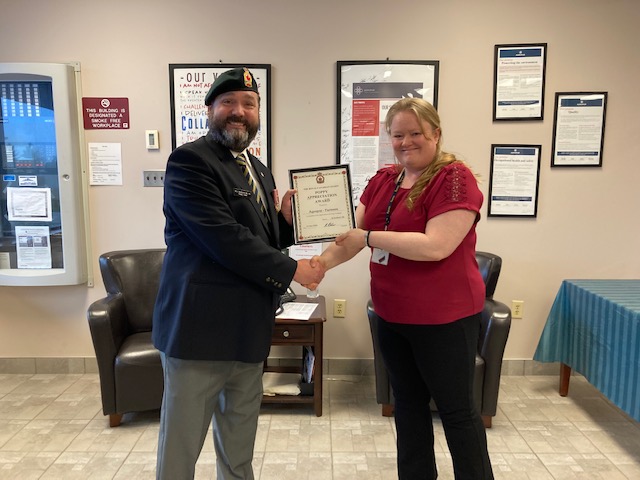 Comrade Rob Pitcher presents Kirsten Rodgers from Agropur/Farmers with a Certificate of Appreciation for their assistance during the 2022 Poppy Campaign