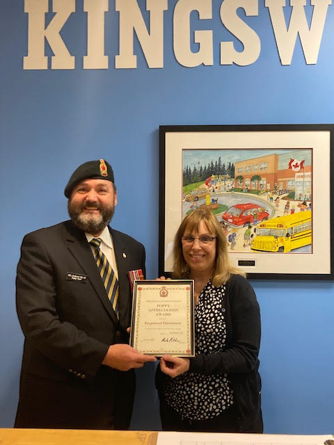 Comrade Rob Pitcher presents Andrea Briand from Kingswood Elementary School with a Certificate of Appreciation for their assistance during the 2022 Poppy Campaign