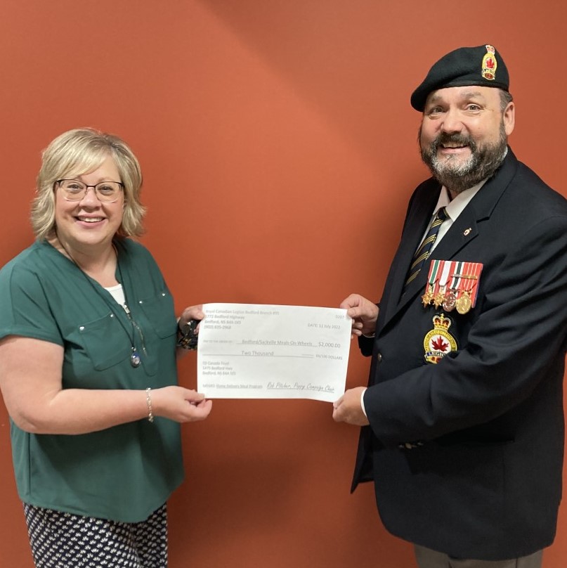 Lisa Franklin from the Bedford/Sackville Meals On Wheels receives a donation from the Bedford Legion's Poppy Campaign Chairman, Comrade Rob Pitcher