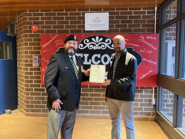 Comrade Rob Pitcher presents Matthew Klasz from Rocky Lake Junior Highschool with a Certificate of Appreciation for their assistance during the 2022 Poppy Campaign