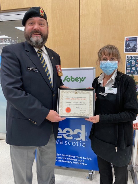 Comrade Rob Pitcher presents a Certificate of Appreciation to Lisa Strach from the Mill Cove Sobeys for their support during the 2022 Poppy Campaign